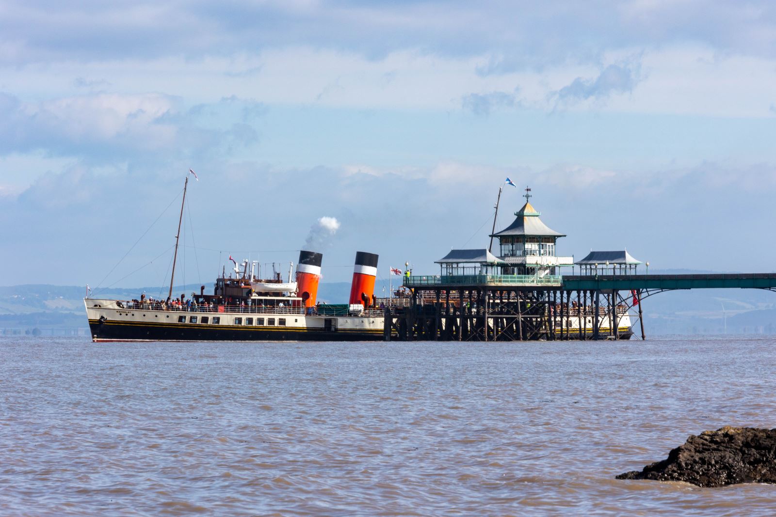 A large paddle steamer about to depart from a pier