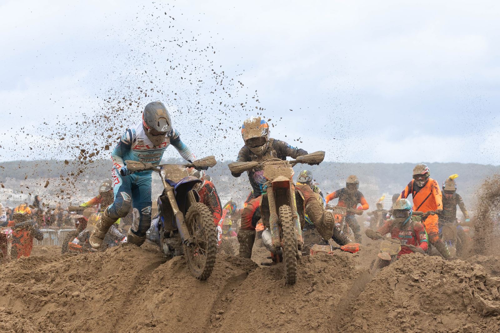 Riders in  the Weston-super-Mare Beach Motorbike Race battle to get over the sand dunes with one rider here pushing his bike through