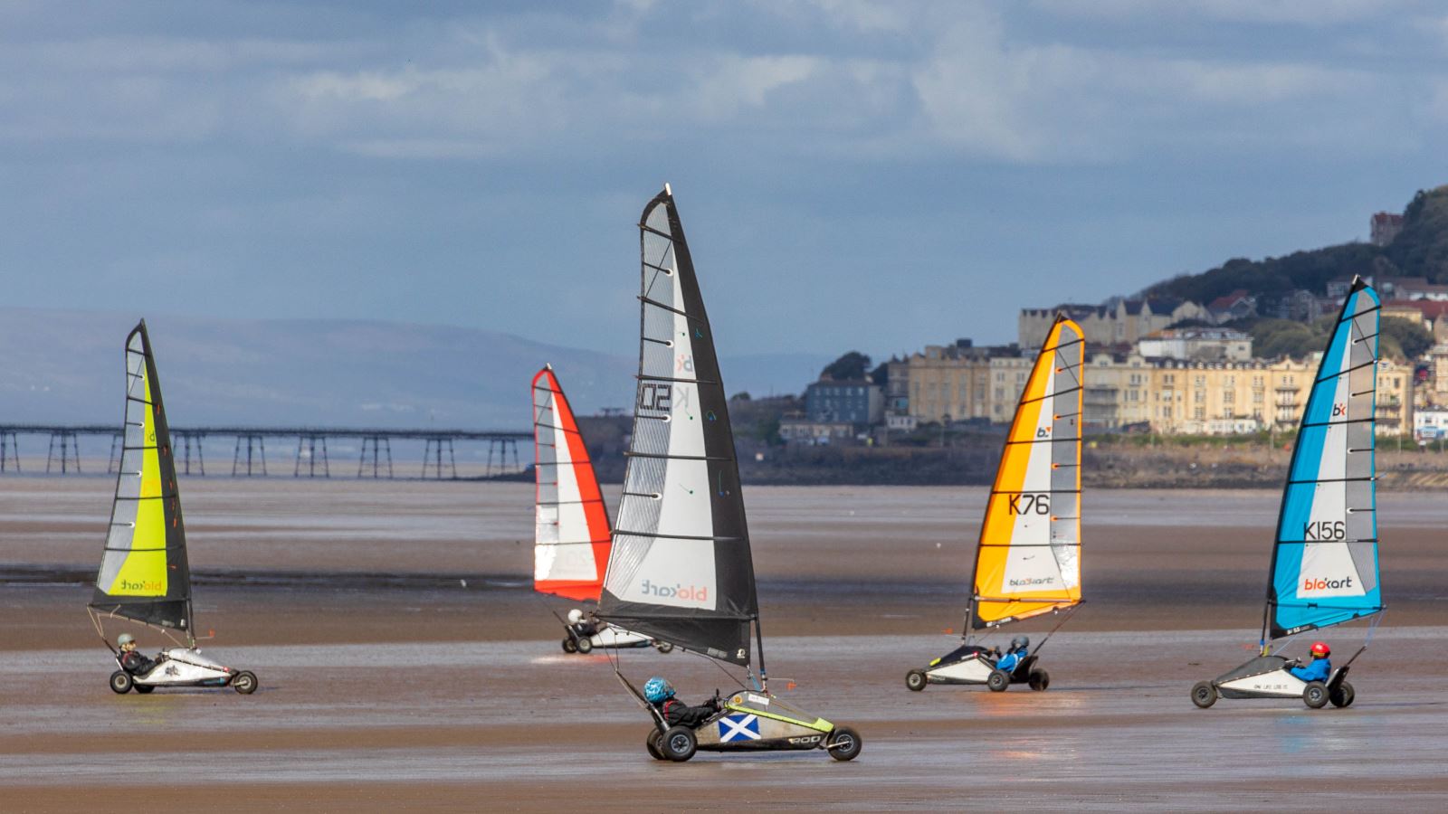 Blokarters racing their sand karts on a beach