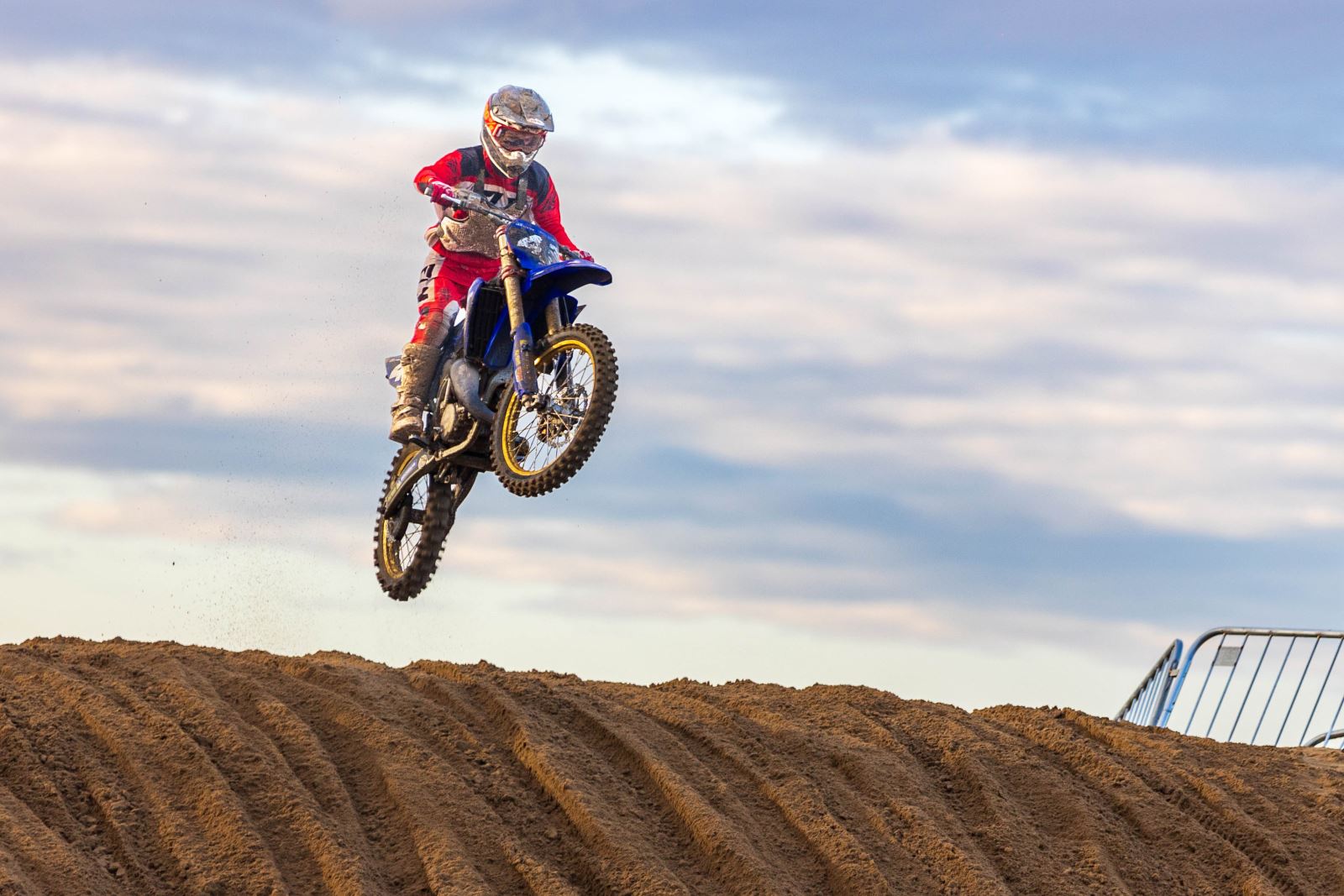 A motocross rider takes off into the air after hitting the top of a sand dune at the Weston-super-Mare Beach Race