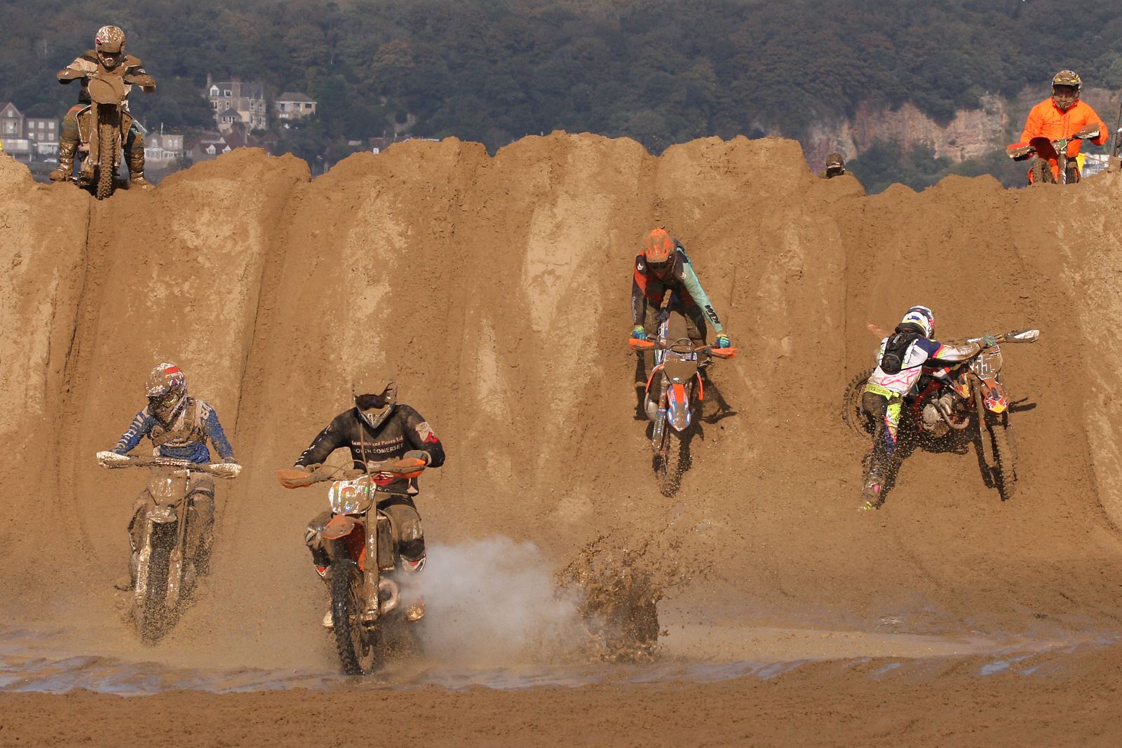 Motorbike riders race down a sand dune in the Weston-super-Mare Beach Race