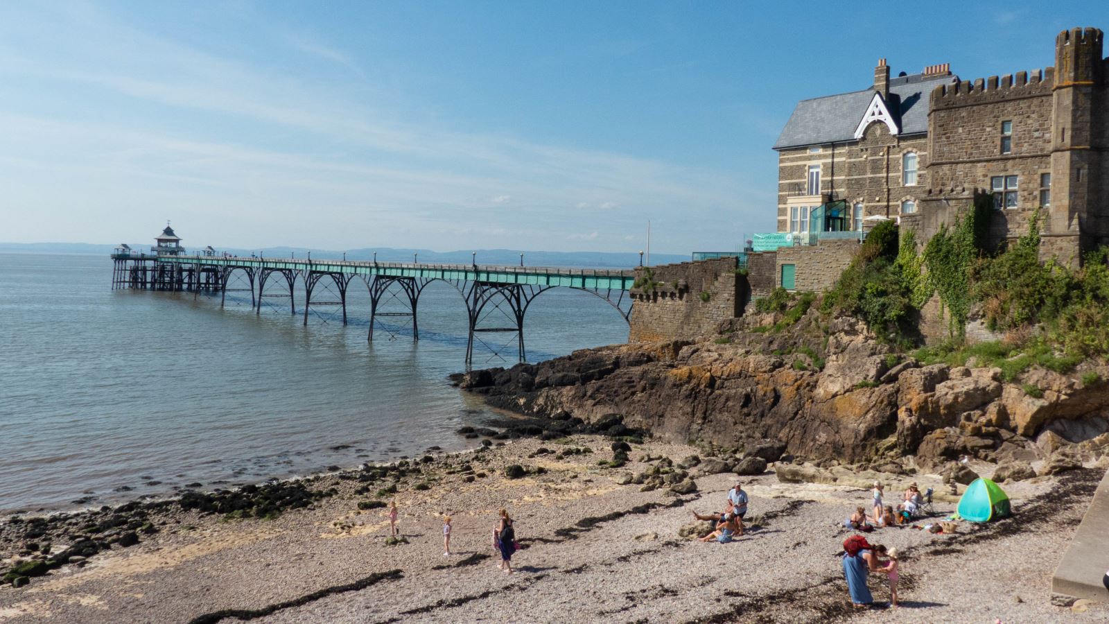 View of a pier reaching out of a rock and stretching into sea